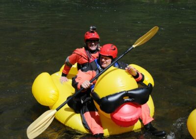 Two rafters floating on a blow-up duck - Endless River Adventures