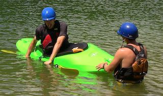 A student preps for a new move during a private kayaking instruction session