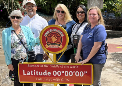 Guests in front of sign in Ecuador - Endless River Adventures